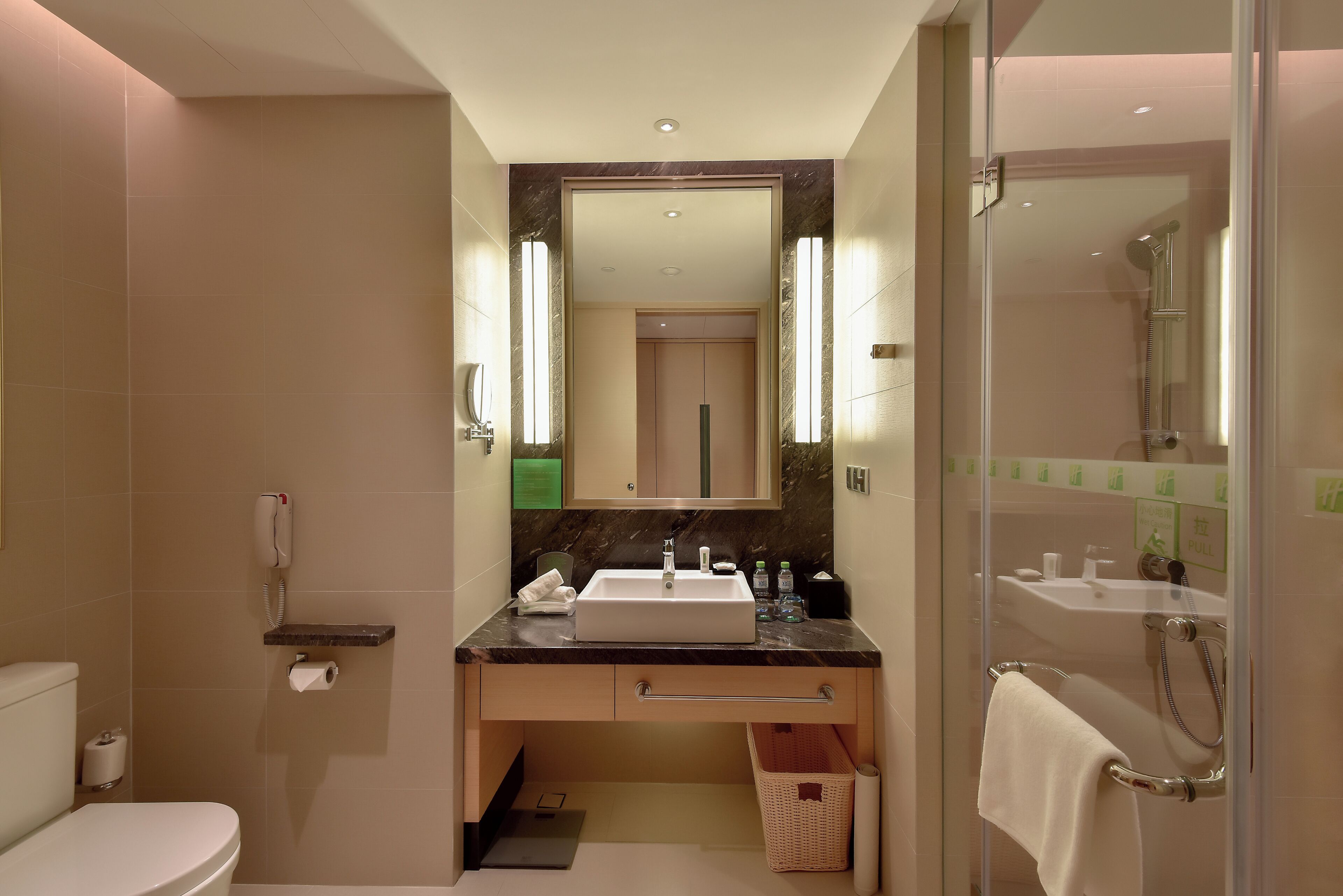 A modern bathroom with a toilet, sink, and shower.