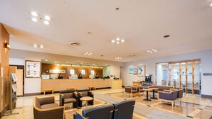 A hotel lobby with a reception desk, seating area, and a coffee machine. - Hotel Grand Terrace Obihiro (Obihiro)