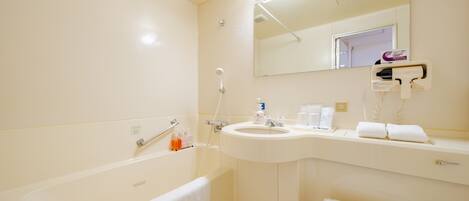 A bathroom with a bathtub, a sink, a mirror, and a towel rack.