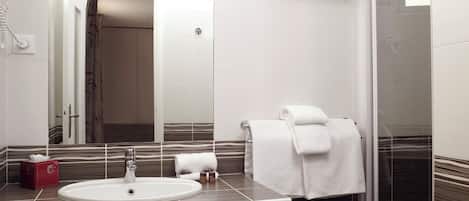A bathroom with a white sink, a towel rack, and a shower area.
