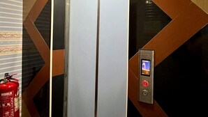An elevator with a digital control panel, surrounded by geometric patterned walls. - Shah Alam Business Hotel (Shah Alam)