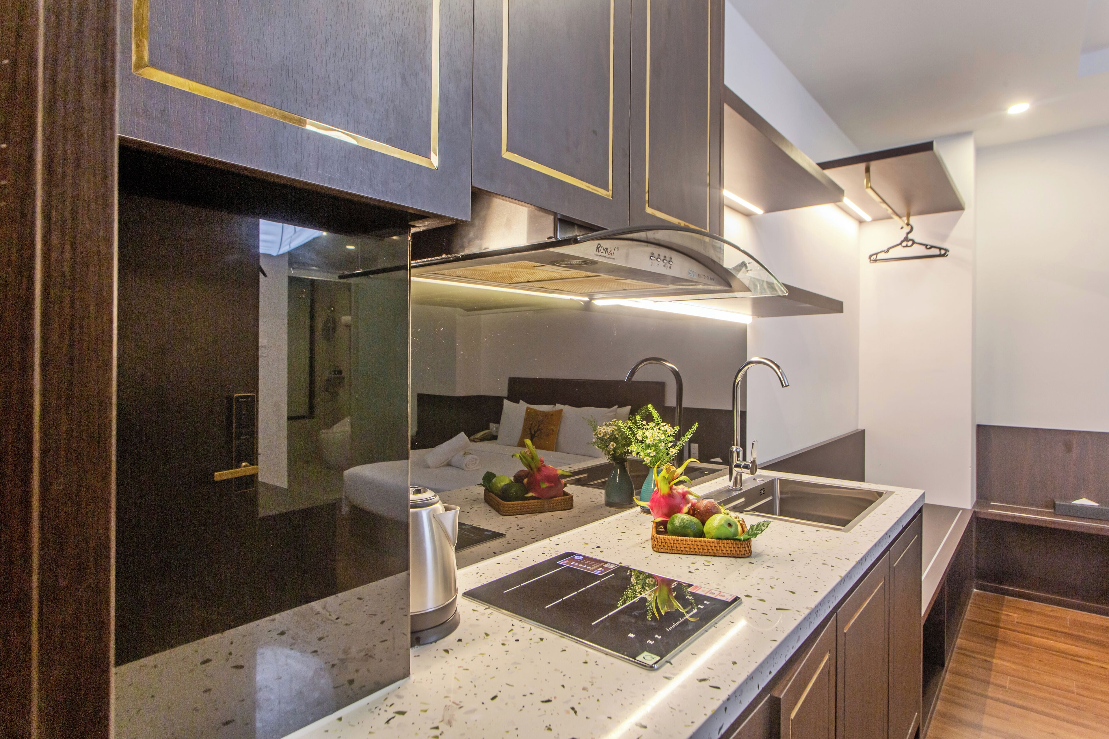 A modern kitchen with a large island, stainless steel appliances, and a breakfast bar.