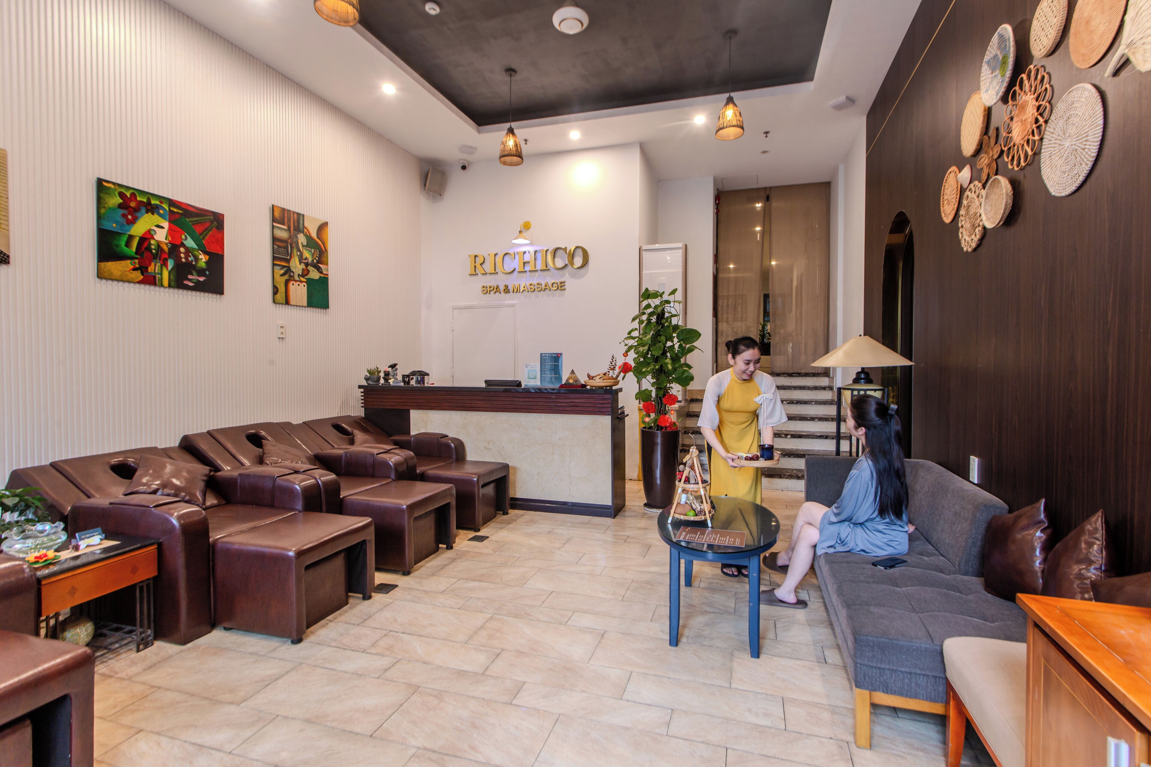 A reception area with a reception desk, a seating area with leather sofas, and a reception counter.