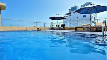 Outdoor pool, open 6:00 AM to 7:00 PM, pool umbrellas, pool loungers