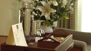 A tray with a menu, bottles, and a small vase of flowers. - Hotel Princess Boutique (Istanbul)