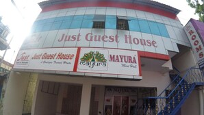 A building with signage for 'Just Guest House' and 'Mayura Mini Hall'. - Just Guest House (Chennai)