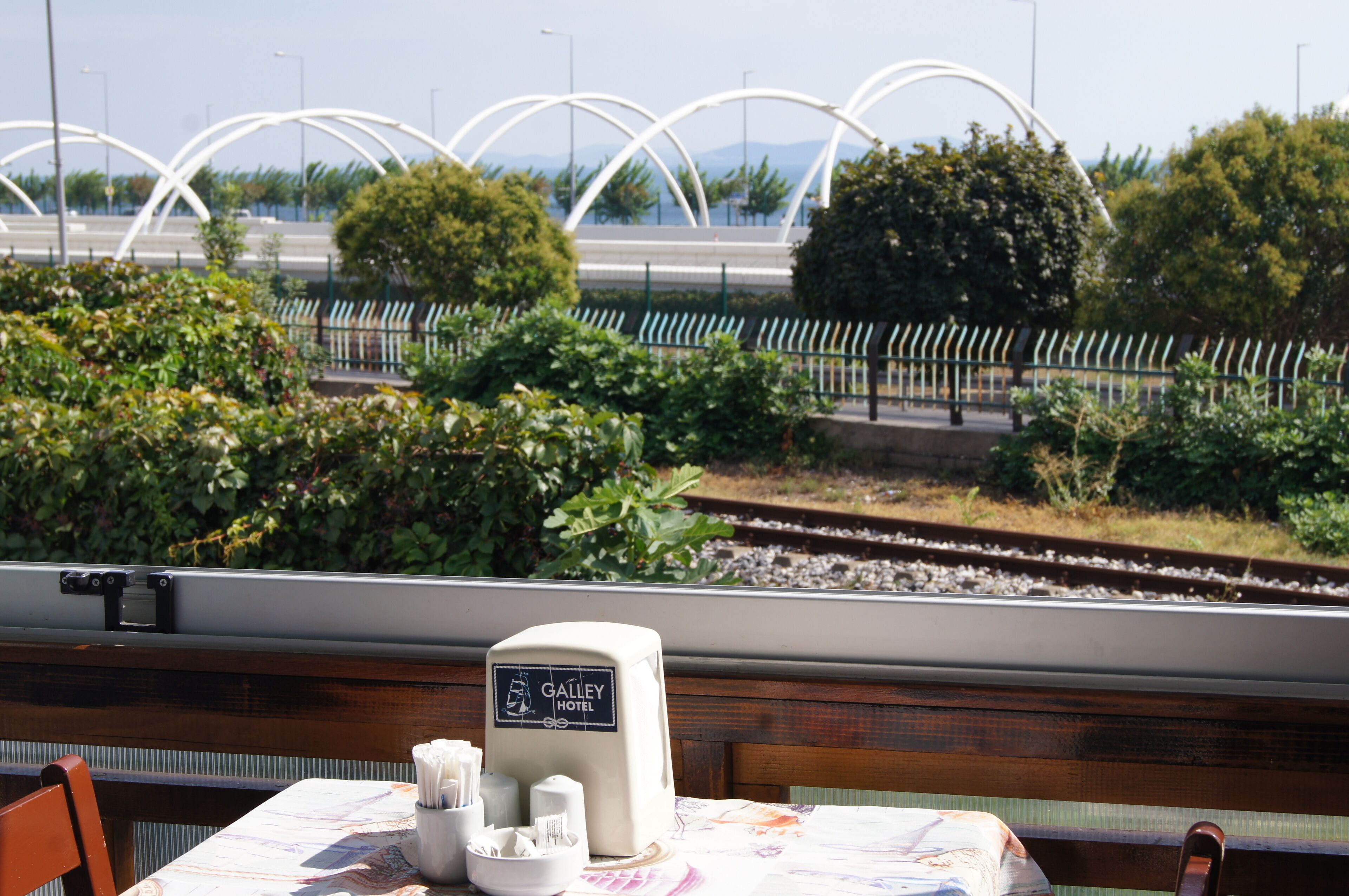 A dining table with a Galley Hotel sign, a menu, and condiments.