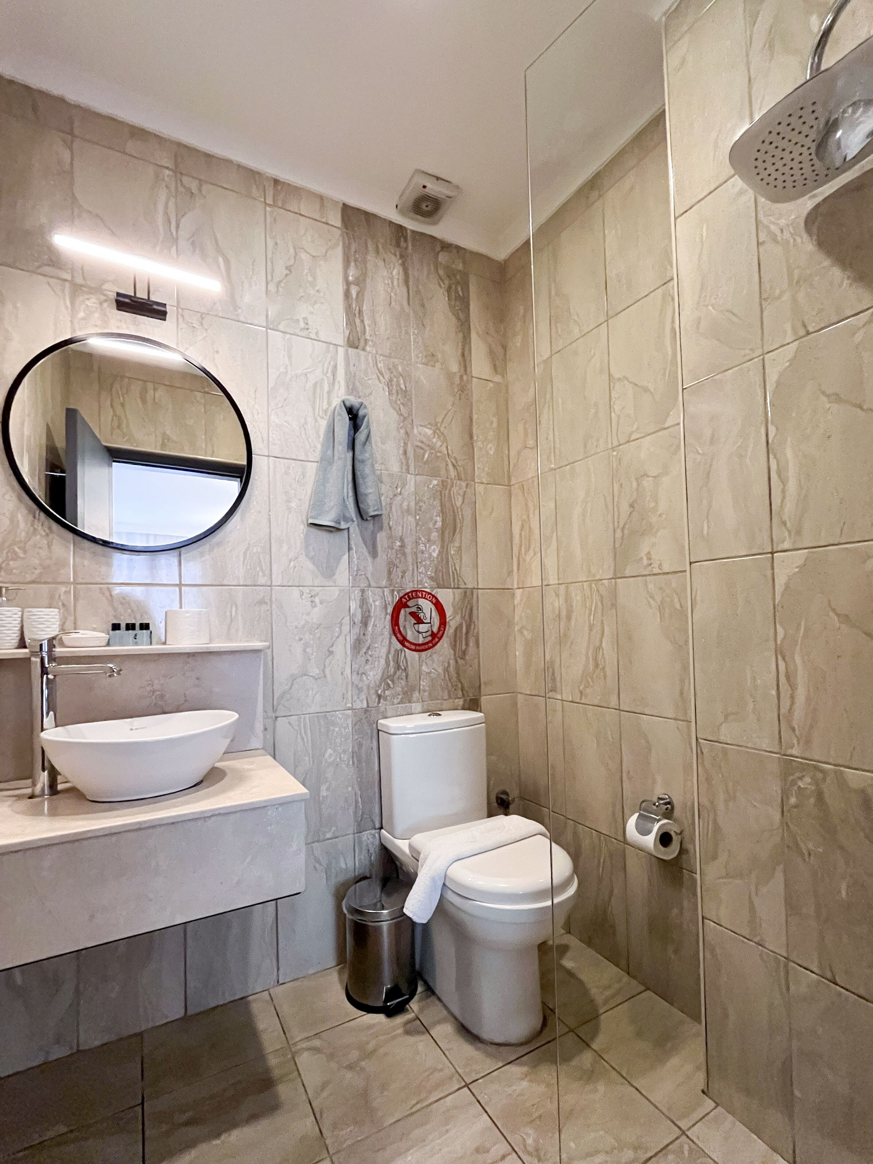 A bathroom with a sink, toilet, and shower.