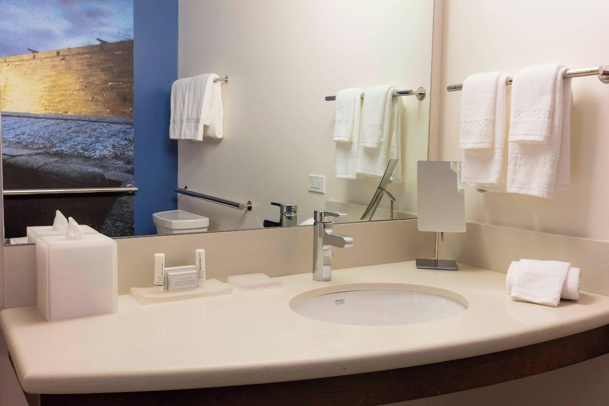 deluxe room, 2 queen beds, courtyard view | bathroom | free toiletries, hair dryer, towels