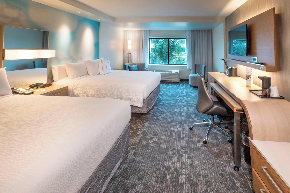 deluxe room, 2 queen beds, courtyard view | desk, blackout curtains, iron/ironing board, free cots/infant beds