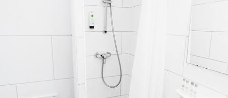 A modern bathroom with a shower, toilet, and sink.