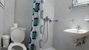 A bathroom with a toilet, shower, and sink. - Solemar Apartments (Rhodes)
