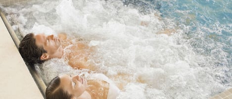 A hot tub with two people lying in it.
