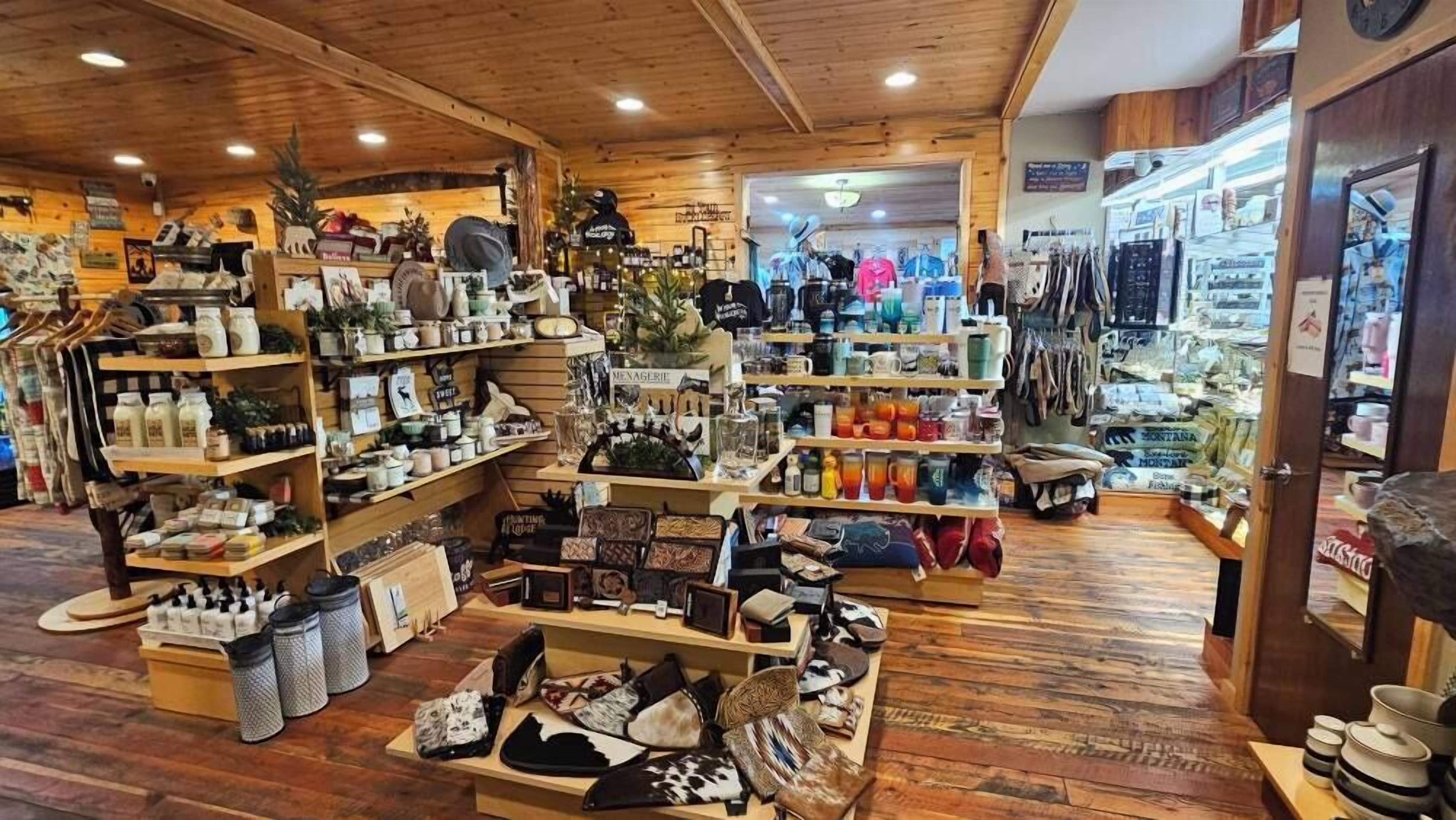 A wooden interior with shelves displaying various items like bags, hats, and kitchenware.