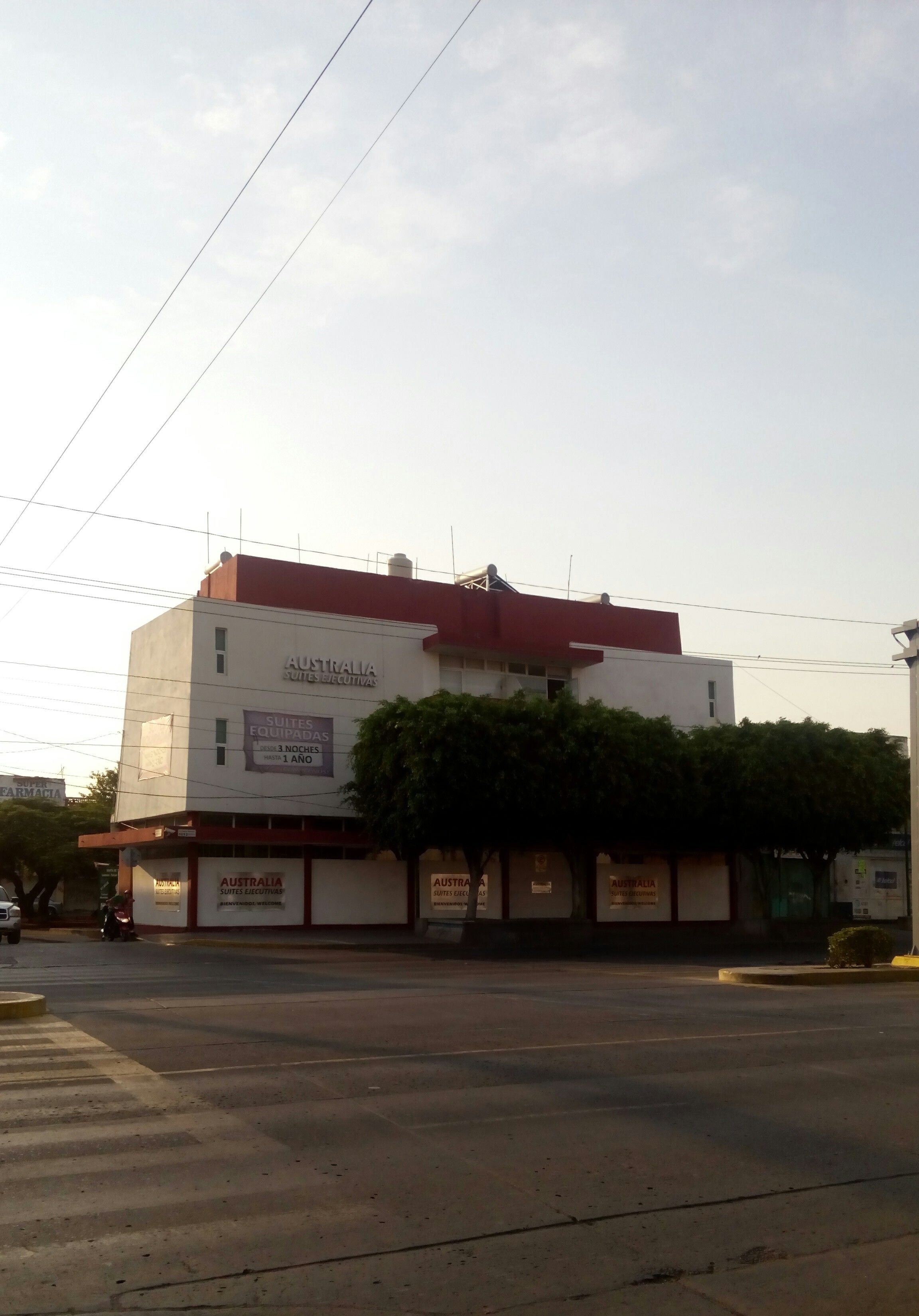 A building with signage for 'Australia Suites Equitativas' and 'Australia Equitativas'.