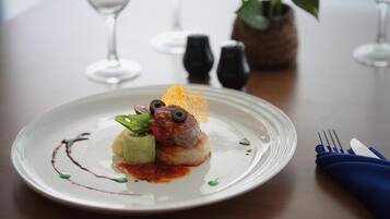 A white plate with a dessert on a table.