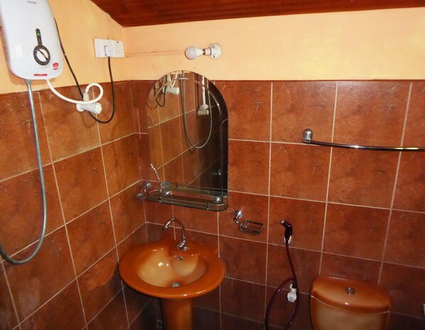 A bathroom with a sink, mirror, and towel rack.