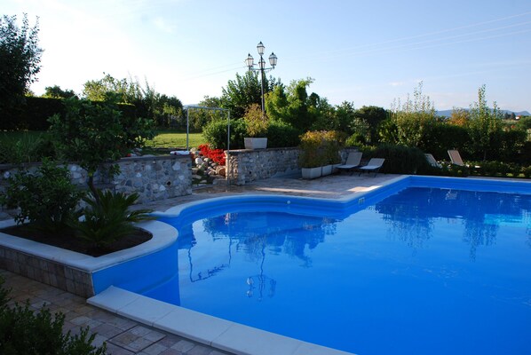 Seasonal outdoor pool, pool umbrellas, pool loungers