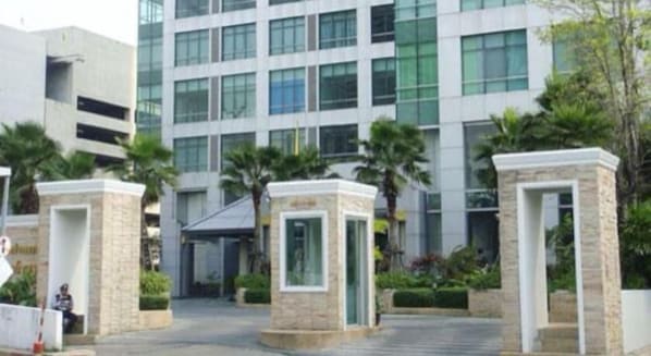 A modern building with a glass facade and a central entrance.