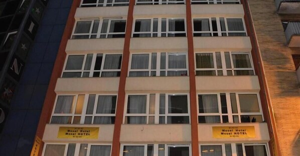 A multi-story hotel building with balconies, a sign indicating 'Mosel Hotel,' and a visible entrance. - Mosel Hotel Frankfurt (Frankfurt)