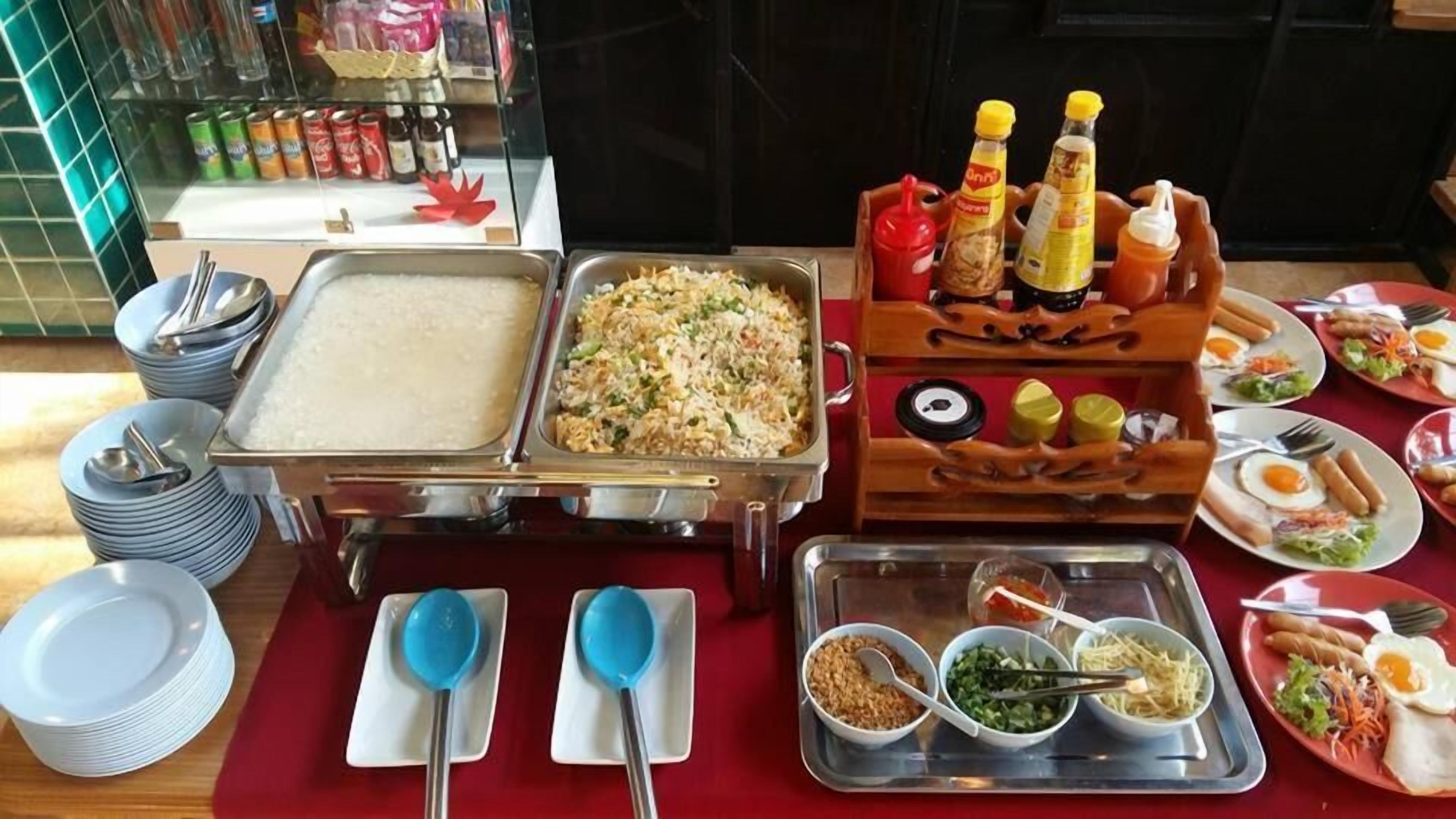 A buffet setup with various dishes, condiments, and utensils.