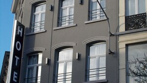 A multi-story hotel building with a prominent "HOTEL" sign on the facade. - Urban City Centre Hostel (Brussels)