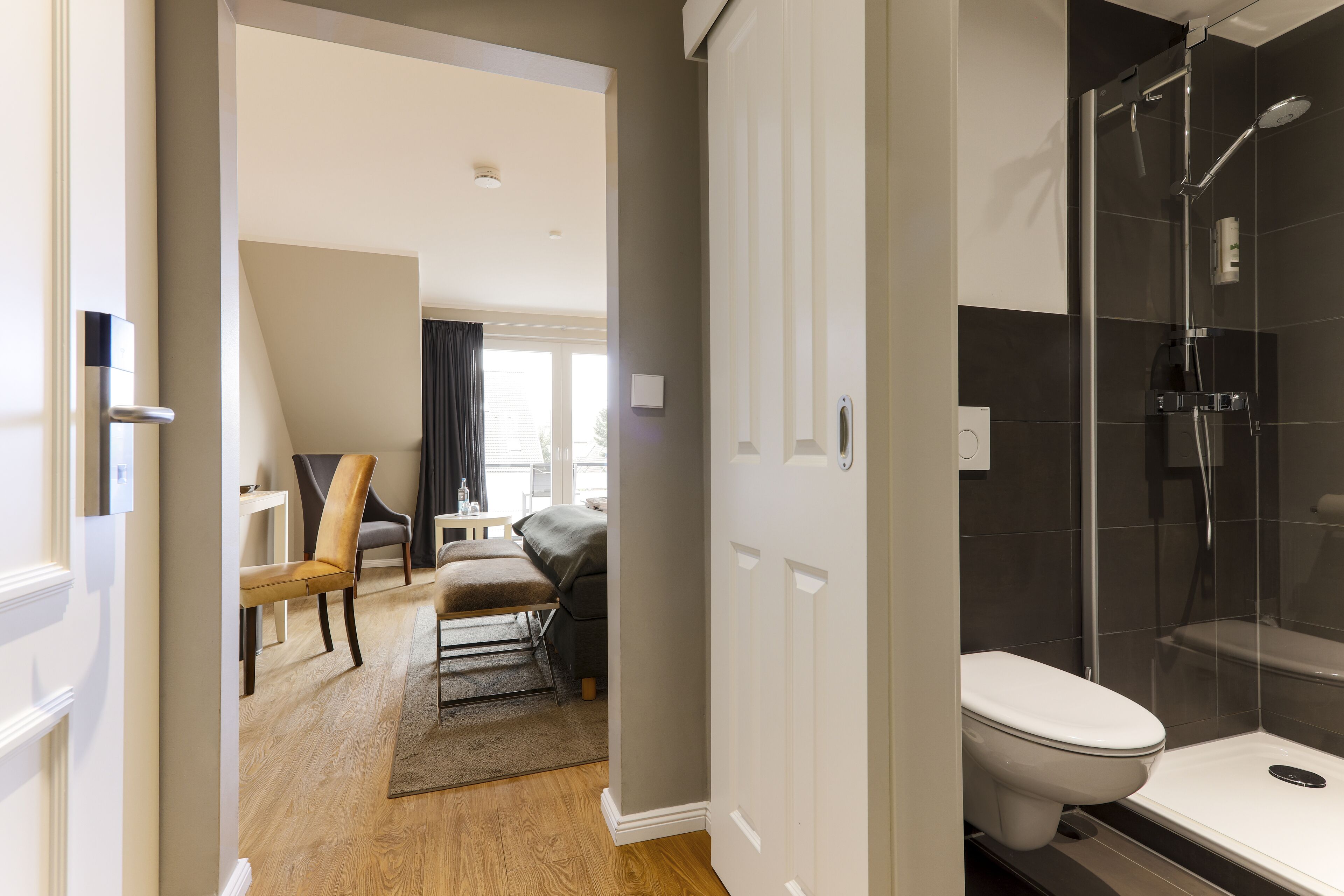 double room with south- facing balcony | bathroom | shower, rainfall showerhead, hair dryer, towels