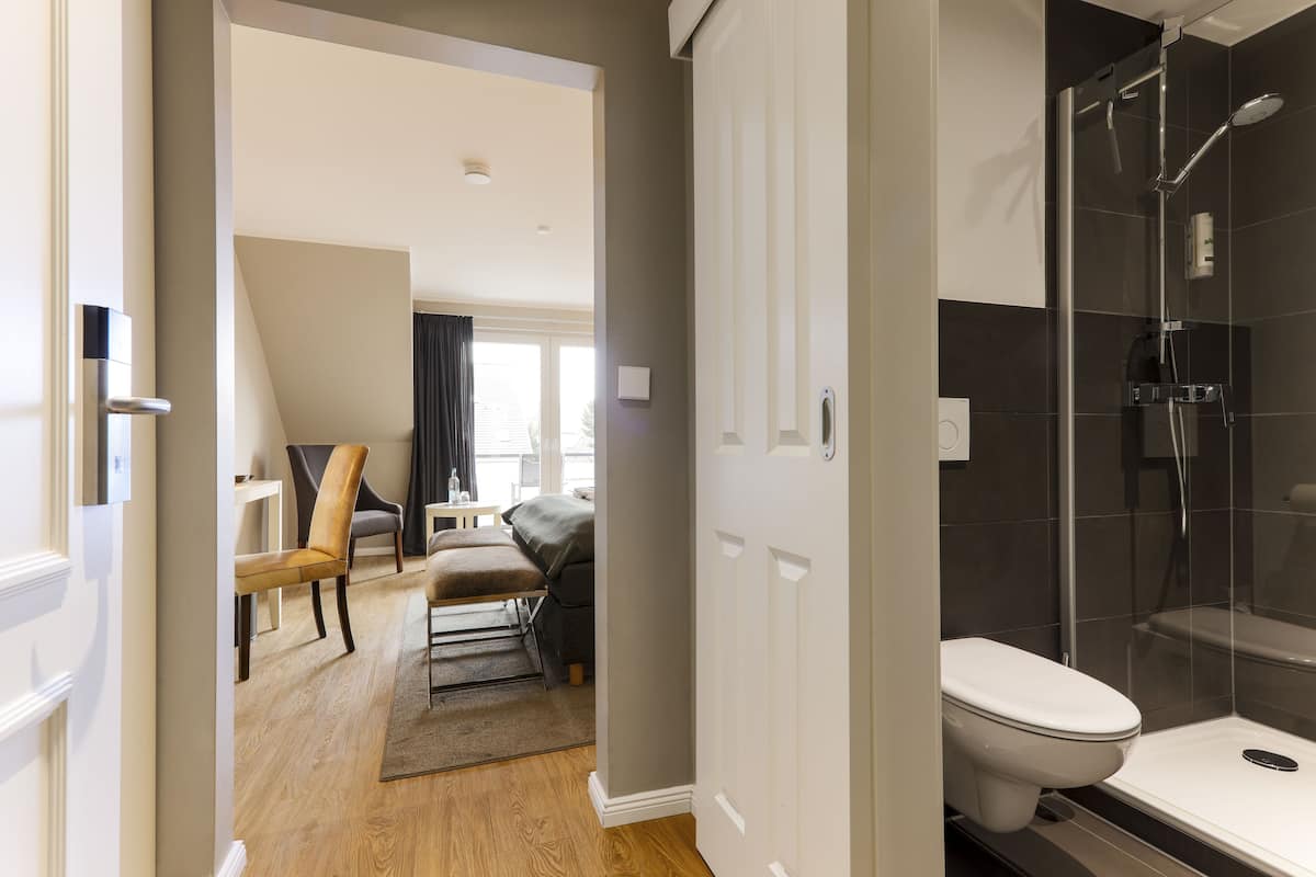 double room with south- facing balcony | bathroom | shower, rainfall showerhead, hair dryer, towels