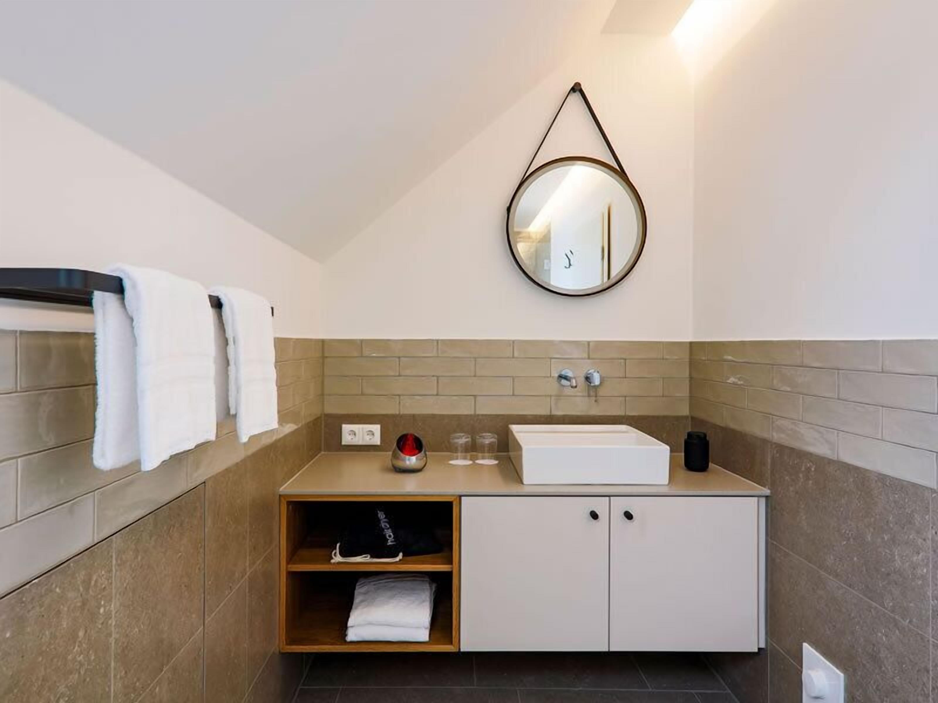 deluxe suite | bathroom | shower, rainfall showerhead, hair dryer, towels