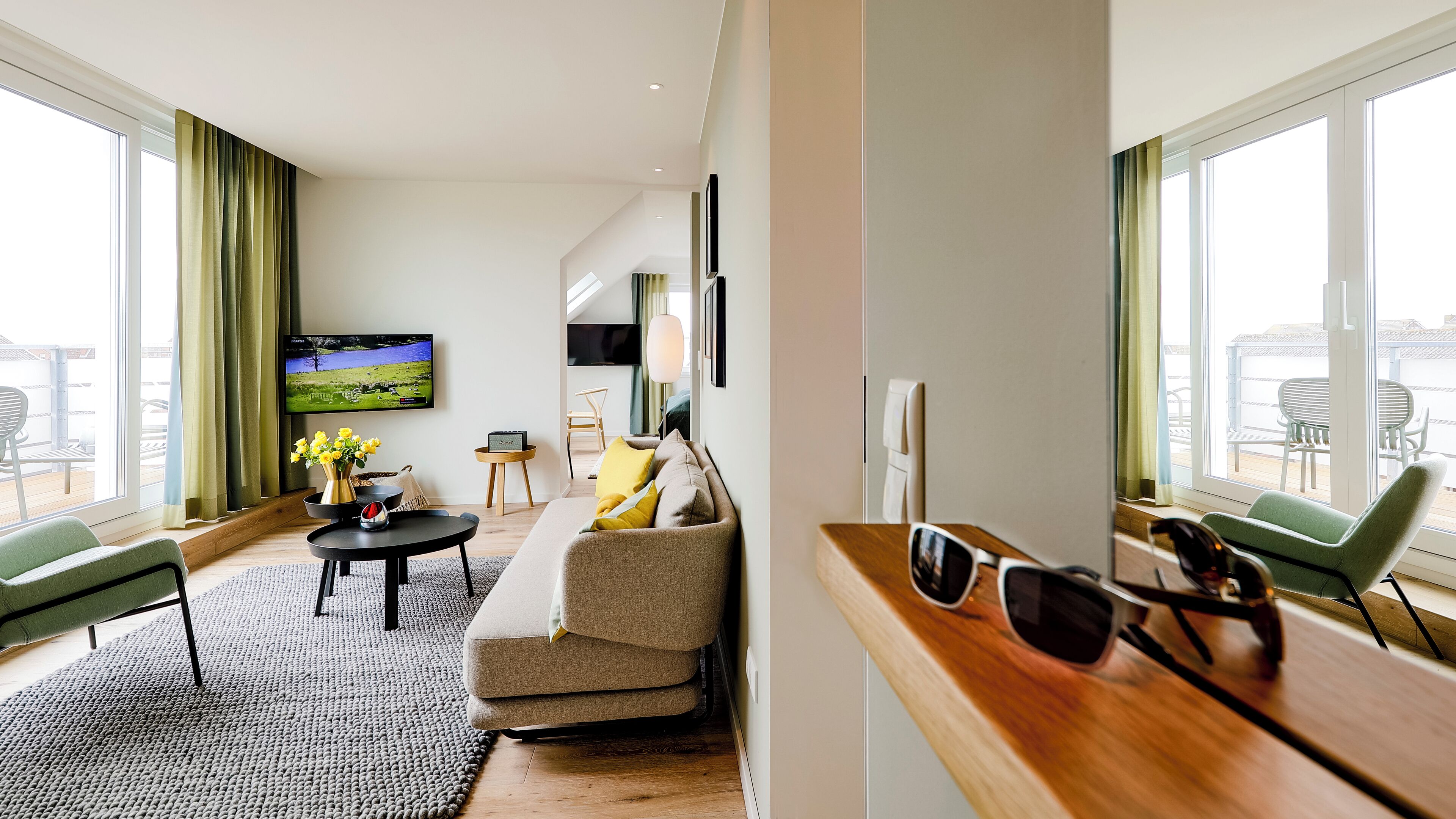 deluxe suite | living area | 65-inch flat-screen tv with satellite channels, tv, books