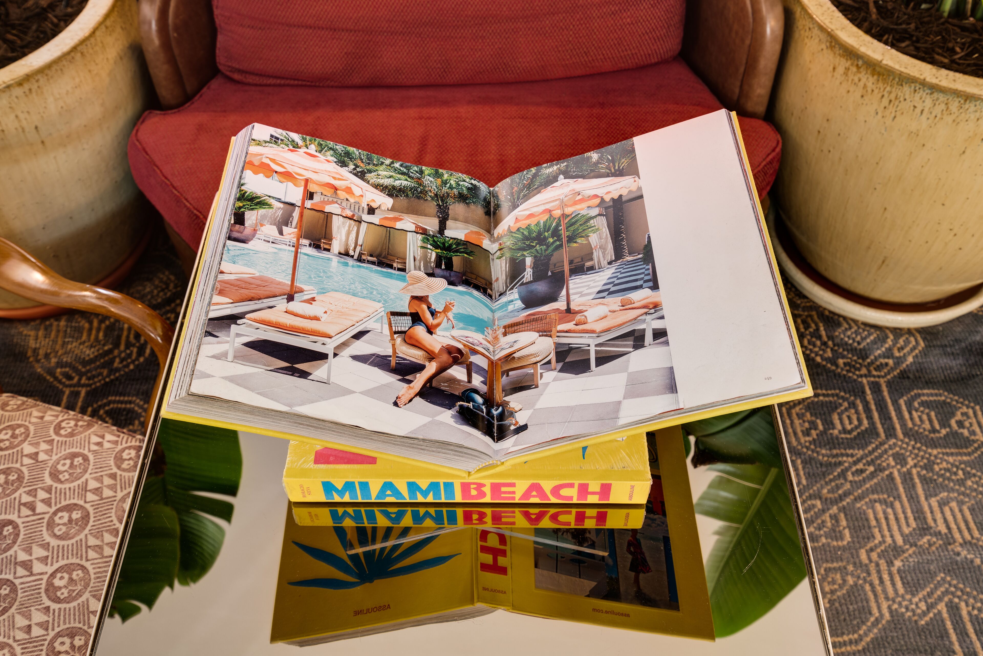 A book titled 'Miami Beach' with a poolside scene on the cover.