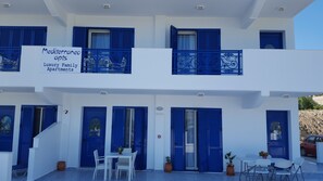 A two-story building with blue shutters and a sign advertising Mediterranean apartments. - Mediterraneo Apartments (Rhodes)