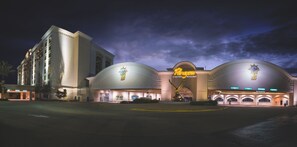 A large, well-lit building with a prominent casino sign, multiple entry points, and a grand entrance with a decorative archway. - Paragon Casino Resort (Marksville)