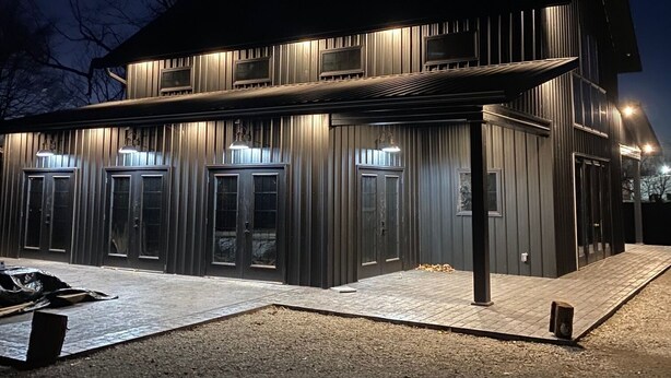 A modern building with a covered entrance, large windows, and a flat roof. - Bourbon Manor B&B (Bardstown)