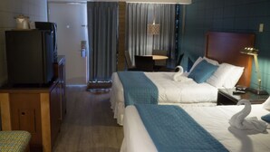 A hotel room with two beds, a television, a desk, and a chair. - Charlroy Motel (Seaside Park)