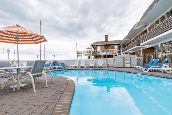 Seasonal outdoor pool, open 10:00 AM to 10:00 PM, pool umbrellas
