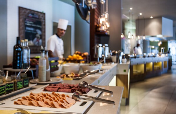 A buffet setup with various food items and condiments. - Garden Court Marine Parade (Durban)