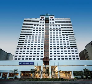 A high-rise hotel with a prominent central entrance, multiple floors, and a well-lit facade. - Garden Court Marine Parade (Durban)