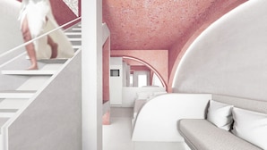 Un interior moderno con una escalera, un sofá y una cama.
