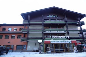 Experience the charm of Unterwirt, a traditional building with a cozy balcony and large windows.