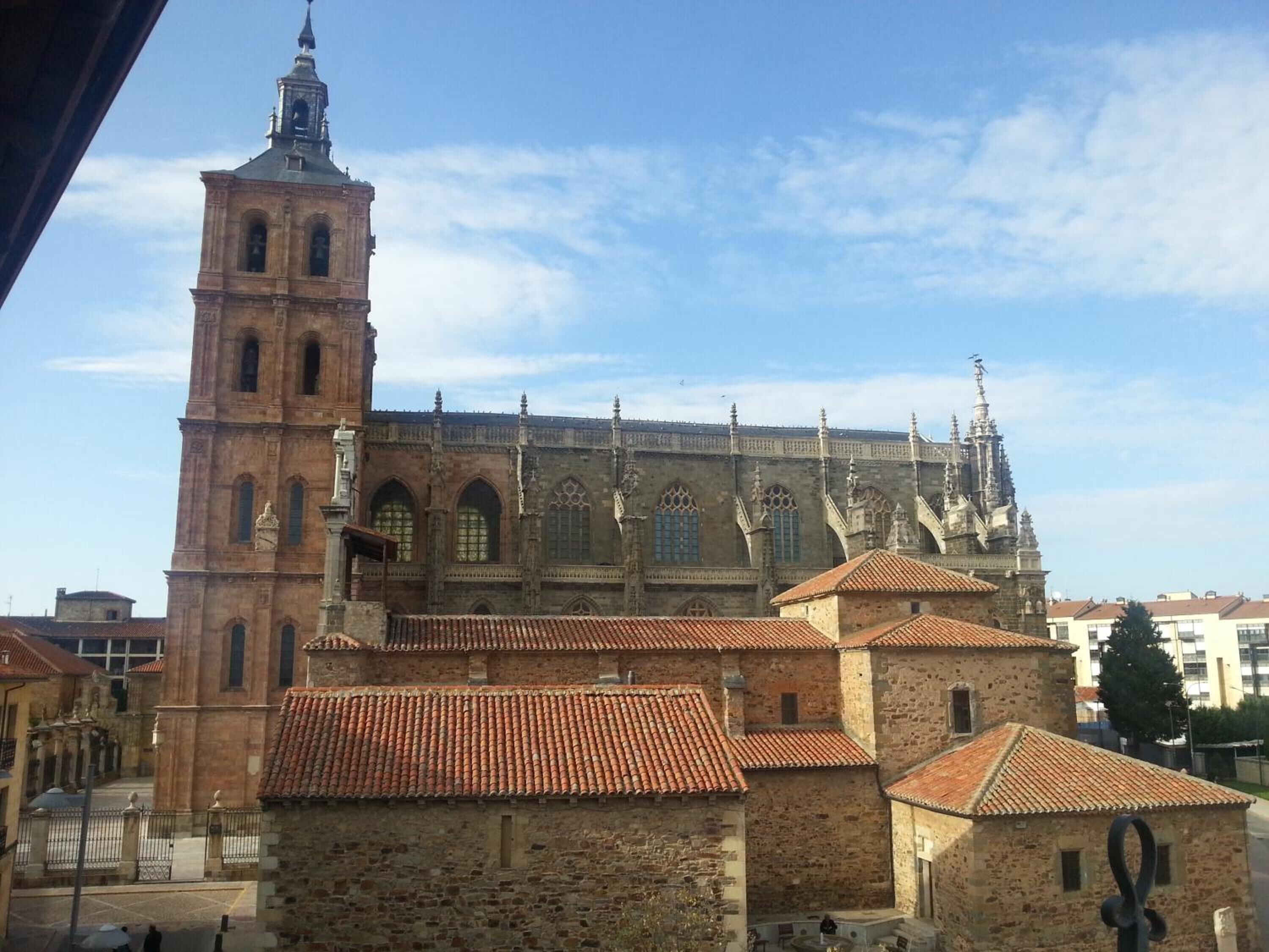 A historic building with a prominent tower and intricate architectural details.