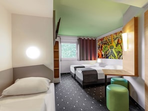 A hotel room with a bed, two bedside tables, a desk, a chair, and a window with curtains. - B&B Hotel Dortmund-Messe (Dortmund)