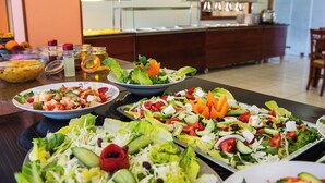 A buffet table with various salads and a buffet counter in the background. - Silver Beach Hotel and Annexe Apartments (Corfu)