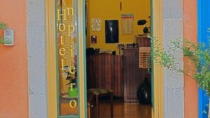 The entrance to Hotel Innpiero with a reception area visible inside. - Inn Piero (Taormina)