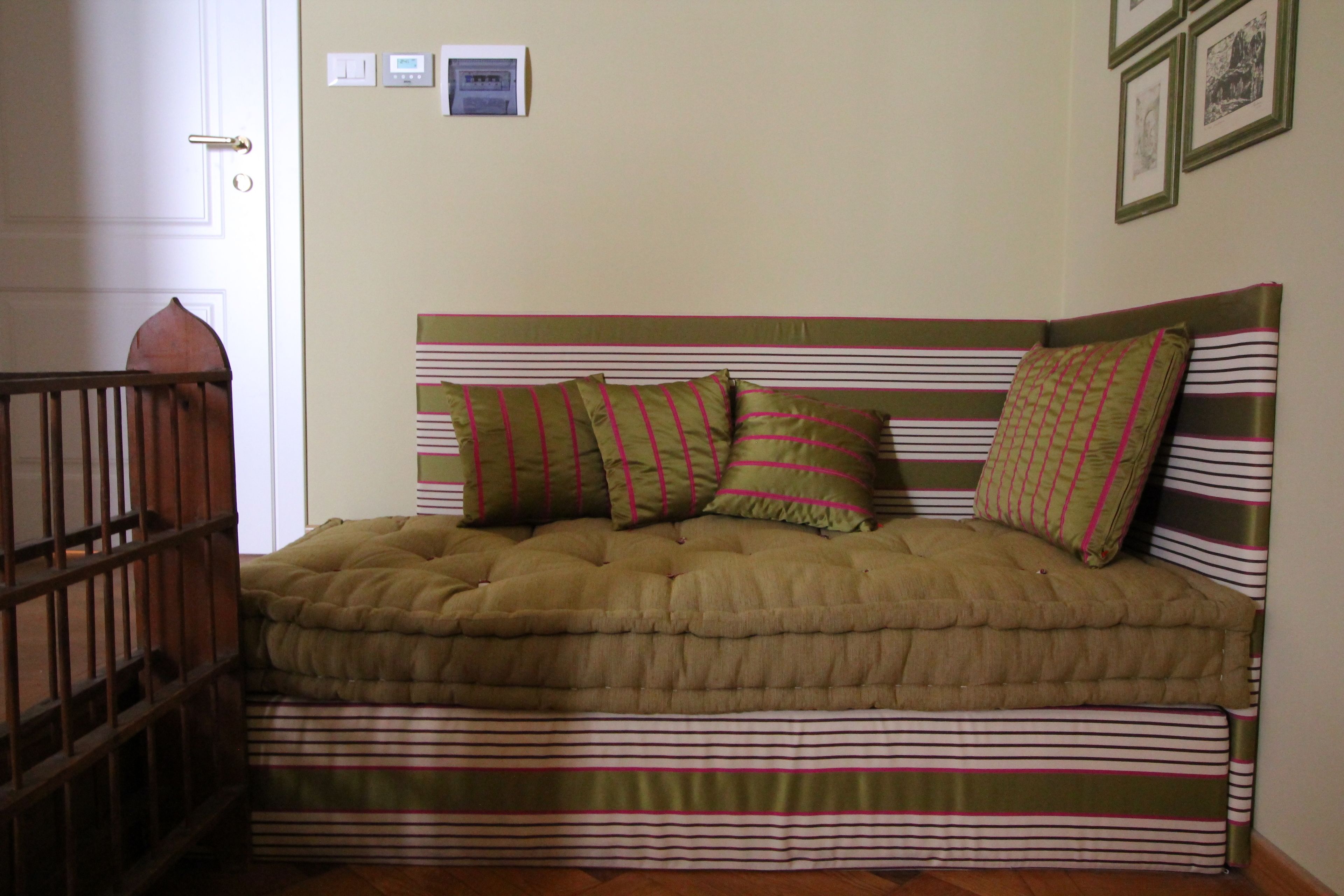 A bed with a striped headboard and multiple pillows.