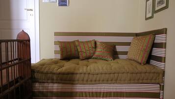 A bed with a striped headboard and multiple pillows.