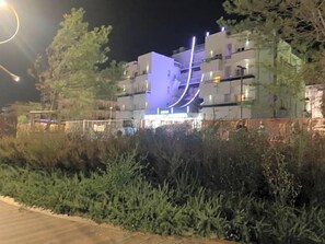 A multi-story building with balconies, surrounded by greenery. - La Fiorita (Rimini)
