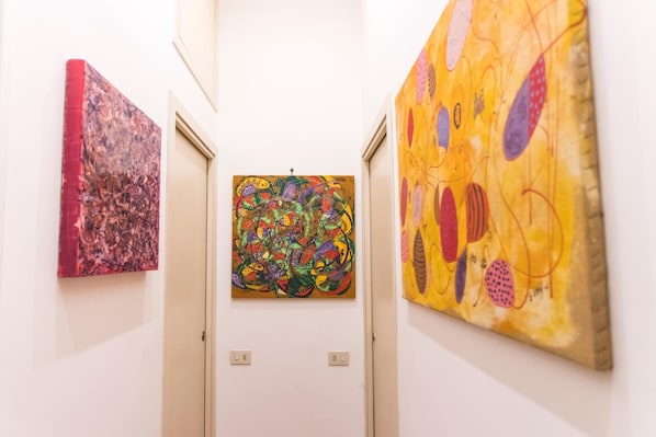 A hallway with three artworks on the walls. - A Casa Cibella (Rome)