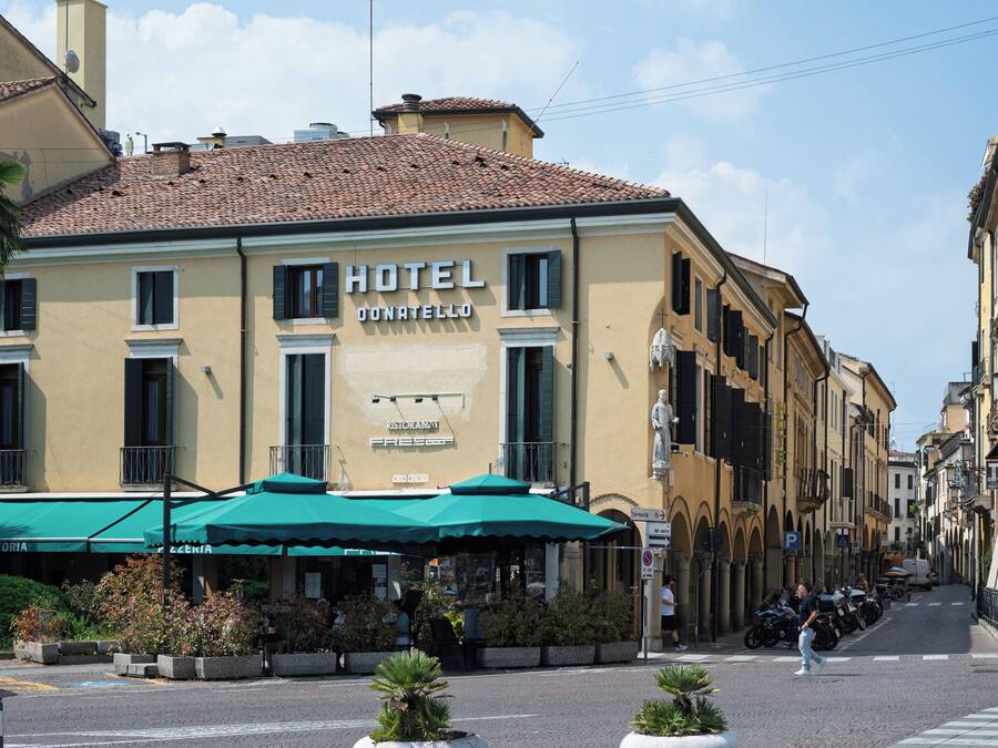 A hotel with a sign indicating a restaurant and a pharmacy.