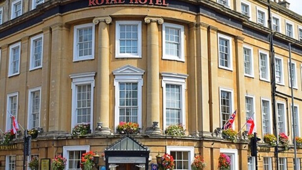 A historic building with a sign reading "ROYAL HOTEL". It features a symmetrical facade with evenly spaced windows and a central entrance. - The Royal Hotel (Bath)